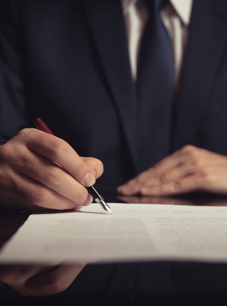 Person signing a contract under pressure, representing duress in agreements