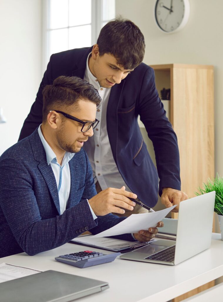 Two businessmen reviewing a document, representing mutual mistake in a contract