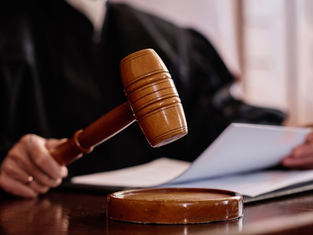 Judge holding gavel with documents on desk representing motion to dismiss